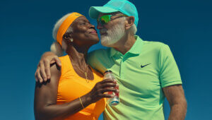 older fit couple staying fit by working out with a trainer